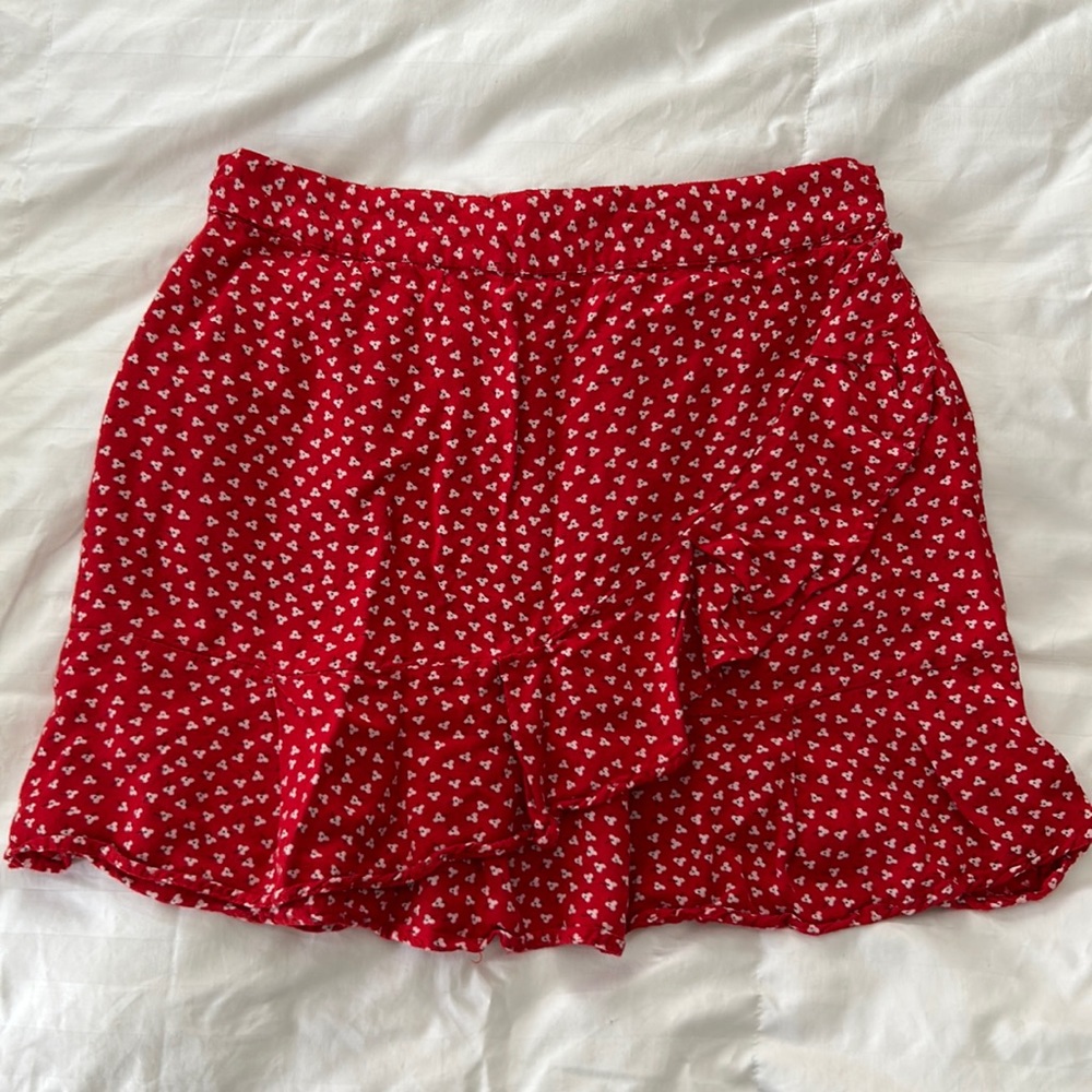 Cute mini skirt with ruffle across the front.